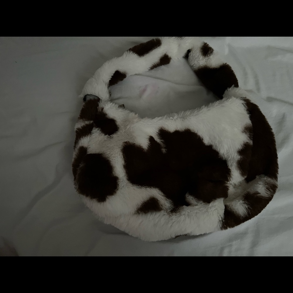 It’s a cow print fluffy purse